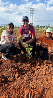 Family planting a sapling