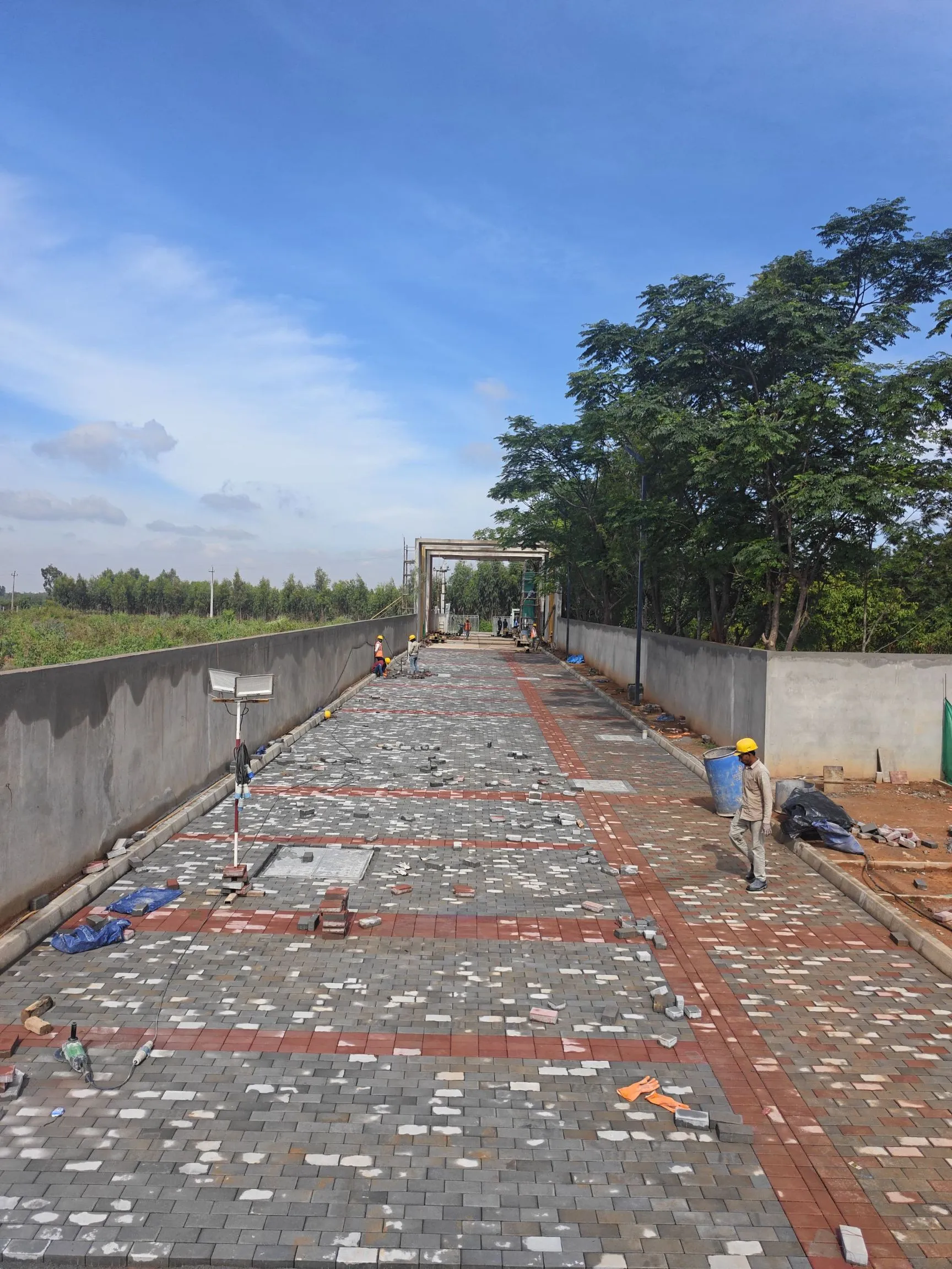 Entrance main road pavers laying work in progress.
