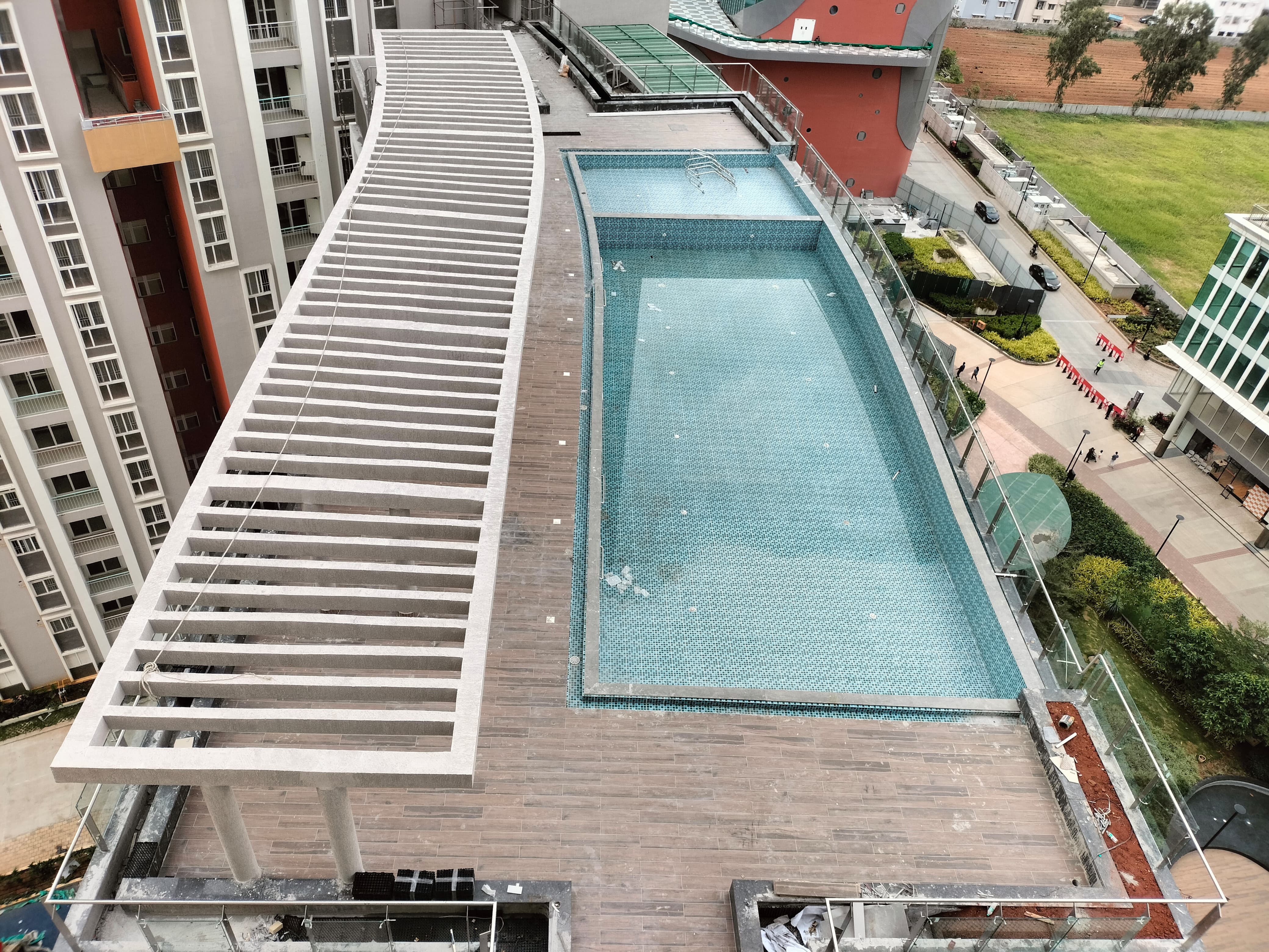 Swimming pool Flooring works completed and drain granite works are in progress