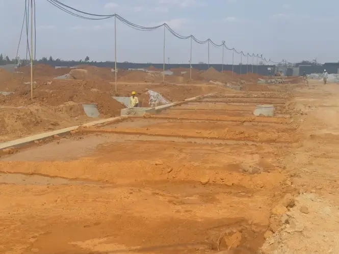 Main road  |electrical pipe laying and sewage line pipe laying works in progress. soil backfilling work in progress.