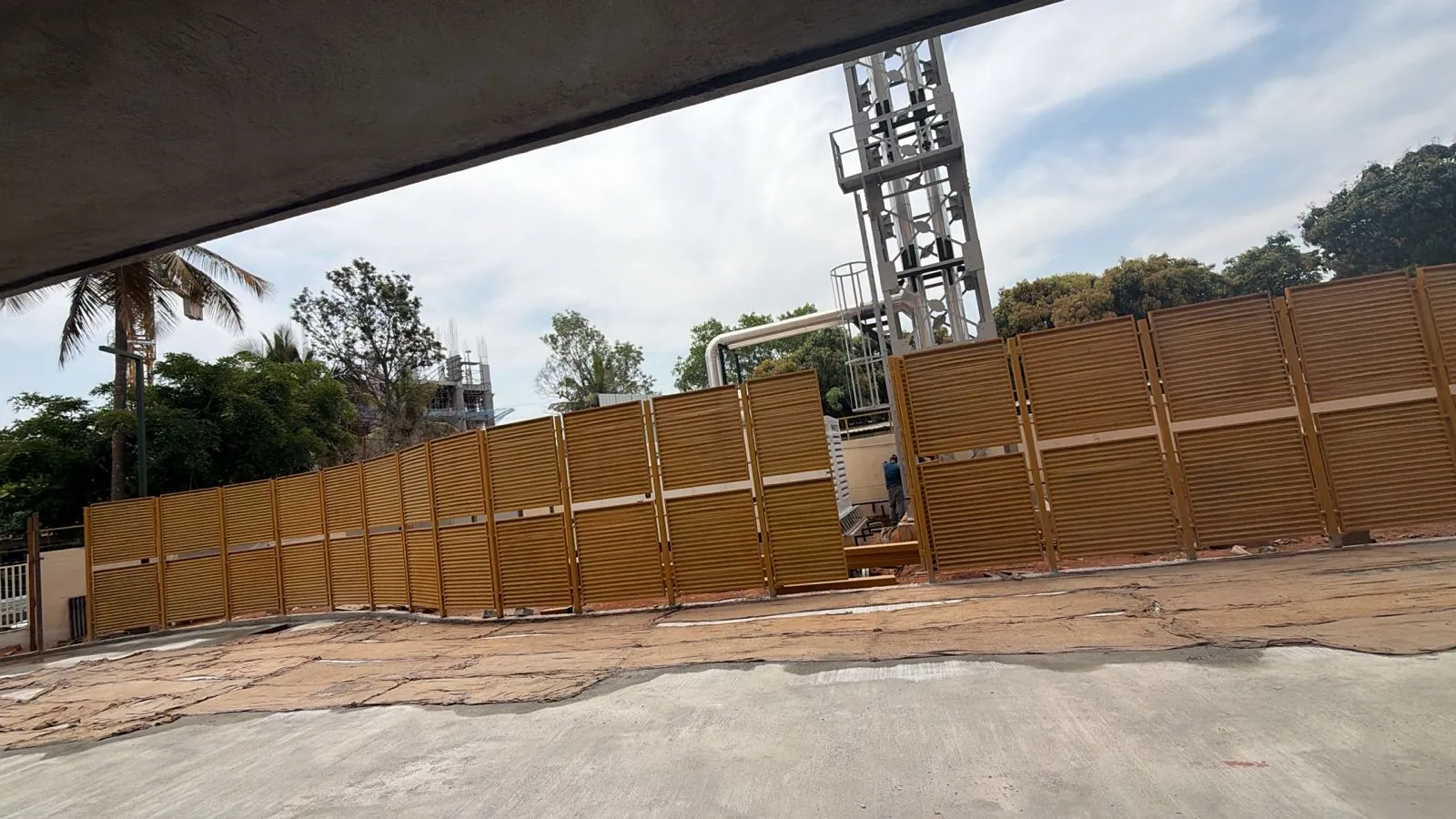 Tower 1 & 2 DG Yard fencing WIP External development Paver's work completed Compound wall first coat completed