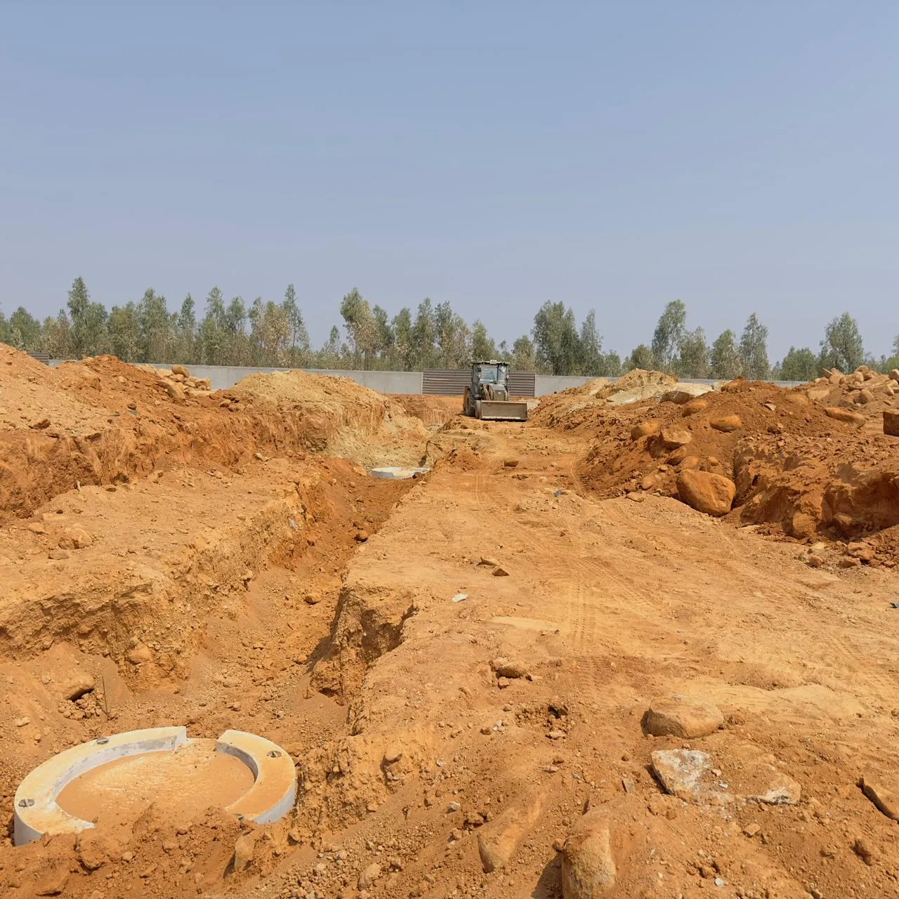 Excavation for sewage line works in progress.